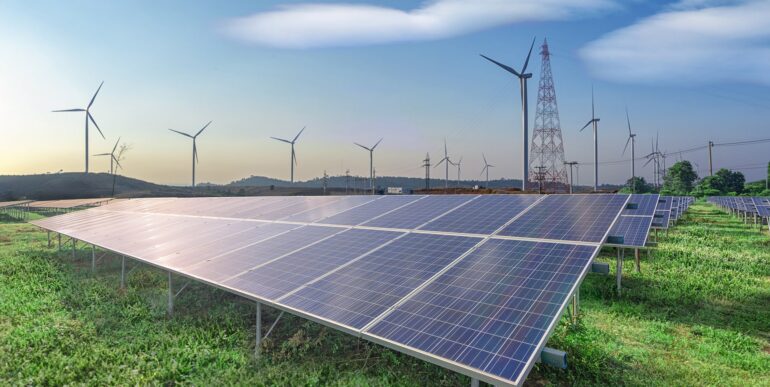 renewable-energy-solar-panels-wind-turbines-green-grass-blue-sky renewable-energy-solar-panels-wind-turbines-green-grass-blue-sky